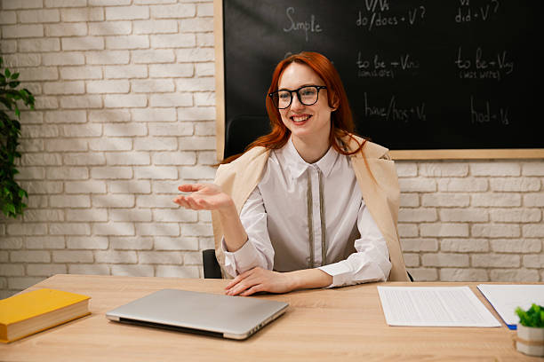 istock Language Teacher Explaining Grammar Tenses to Attentive Students in Classroom 2218150399