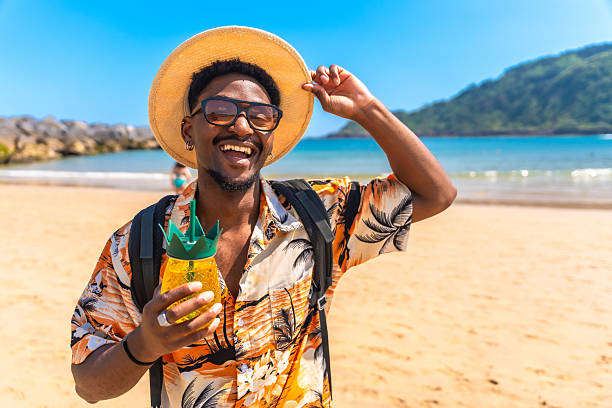 istock Young man enjoying summer vacation on a sunny beach 2218150629
