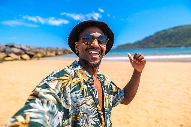 istock Young man taking a selfie on a tropical beach giving thumbs up 2218150670