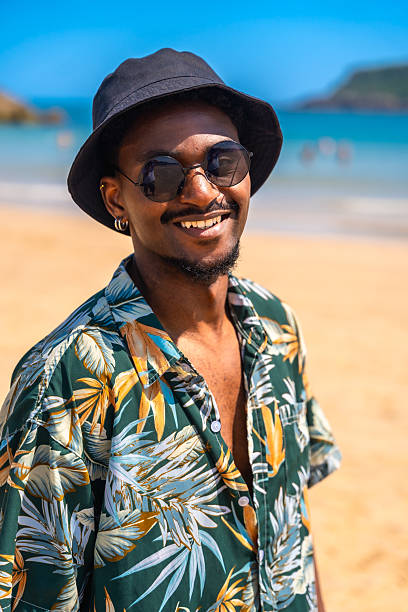 istock Young man smiling on a sunny beach 2218150677