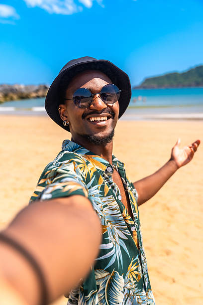 istock Young man taking a selfie on a tropical beach 2218150681