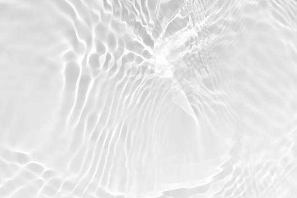 istock White water with ripples on the surface. Defocus blurred transparent white colored clear calm water surface texture with splashes and bubbles. Water waves with shining pattern texture background. 2218150904