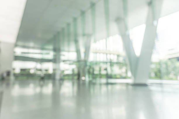 istock Blurred business office building lobby or hotel blur background interior view toward reception hall, modern luxury lounge, white room space with blurry corridor and glass wall 2218155266