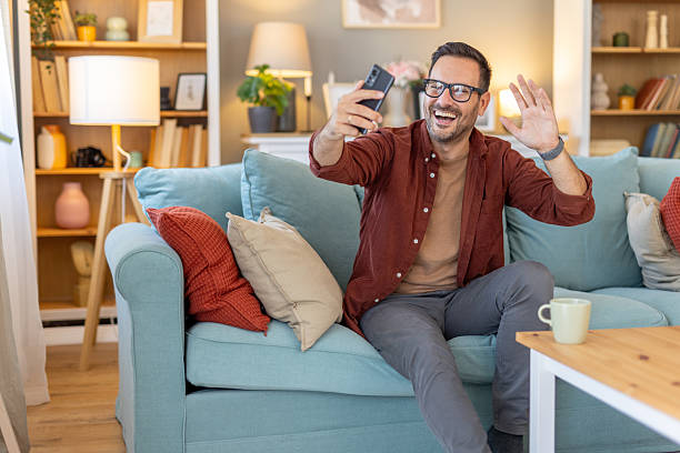 istock Man blowing a kiss while on a video call in his living room 2218155483