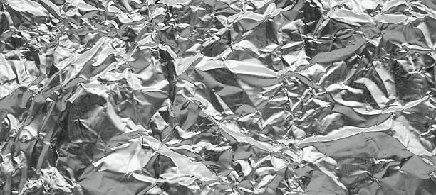istock Shiny metal silver gray foil leaf crumpled texture background 2218155566