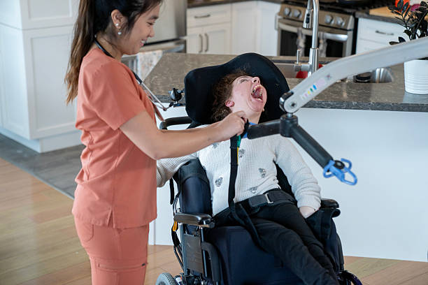 istock Caregiver Assisting Person in a Wheelchair in a Modern Kitchen Setting 2218155829