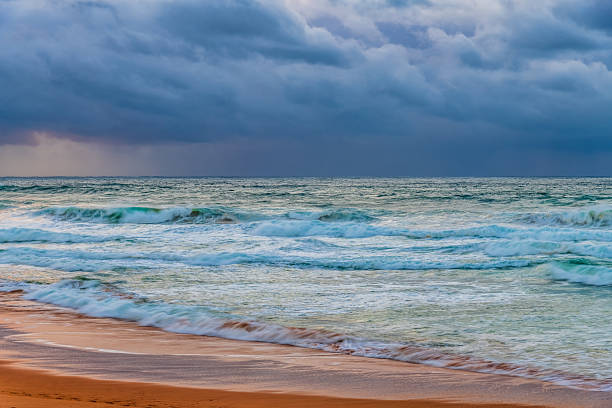 istock Moody sunrise with waves at the seaside 2218162035