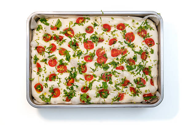 Focaccia Dough in a Tray with Cherry Tomatoes and Herbs