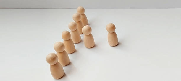 istock Leadership dynamics in team settings minimalist studio wooden figures neutral background top-down view group behavior 2218169412