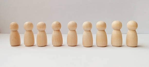 istock Wooden figurines line-up neutral background object display minimalist environment eye-level view artistic concept 2218169463