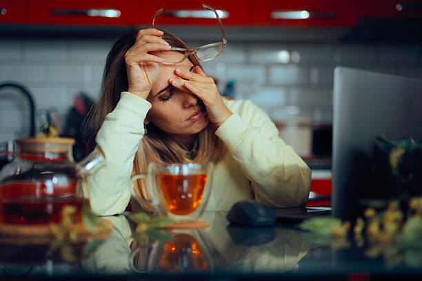 Stressed Woman Working From Home Drinks Tea to Relax