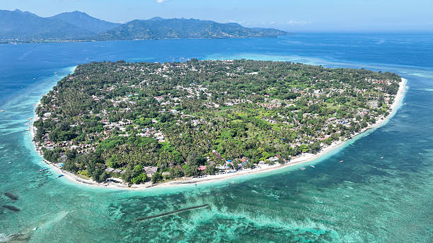 istock Gili Air lush landscape is surrounded by turquoise waters and white beaches, with panoramic views of nearby mountains. An ideal image for island getaway inspiration 2218170333