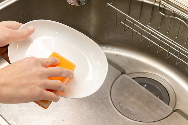 istock Wash the dish with a sponge soaked in detergent 2218173737