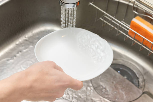 Washing the dish in the sink