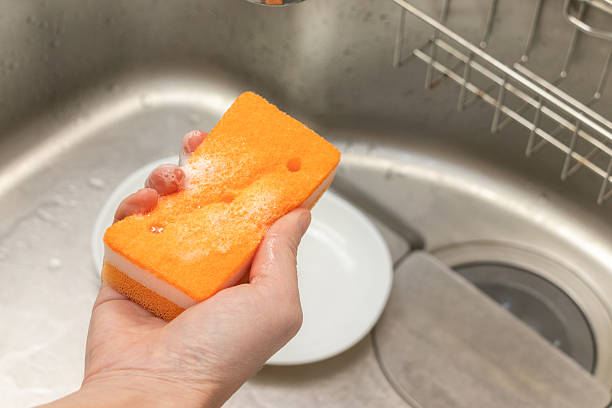 istock Wash the dish with a sponge soaked in detergent 2218173741