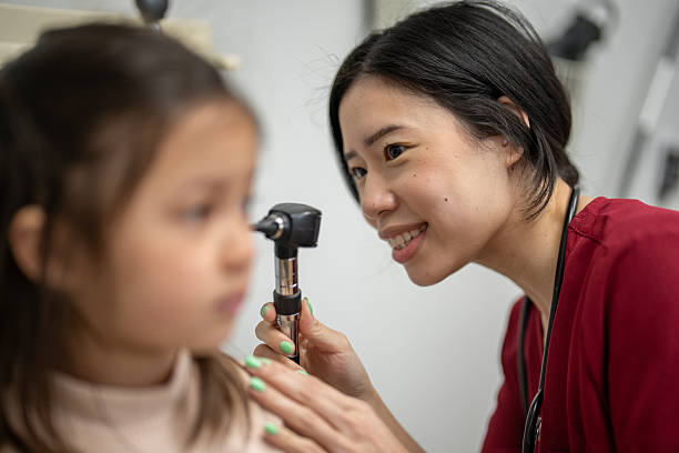 istock Nurse Practitioner Performs Ear Examination on Young Patient at Healthcare Clinic 2218178373