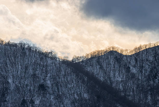 istock Snow covered mountain with overcast weather background 2218181044