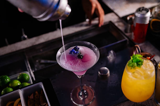 istock Bartender Pouring Purple Floral Cocktail in Night Bar 2218182884