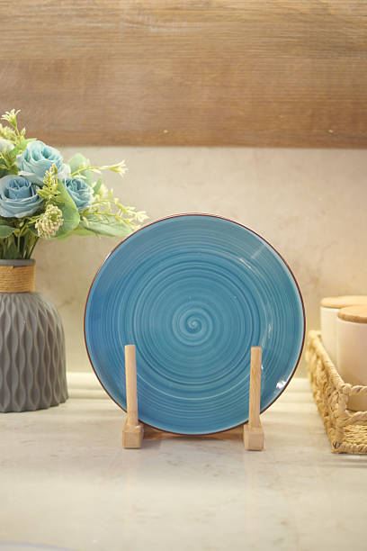 istock Decorative blue plate on wooden stand in modern kitchen setting 2218183523