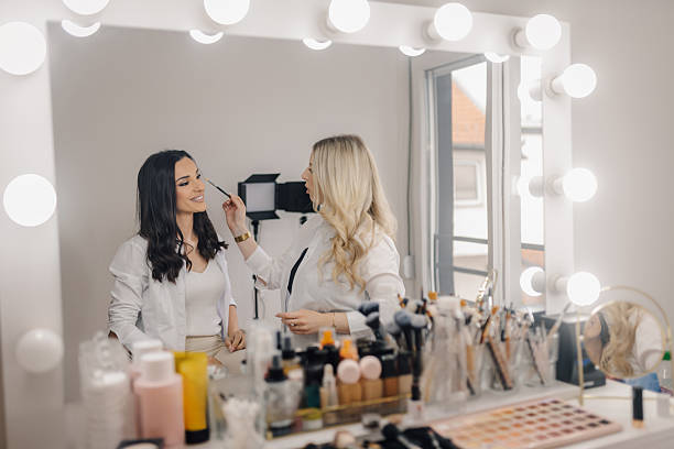 istock Makeup artist applying makeup to a client in a beauty salon 2218184430