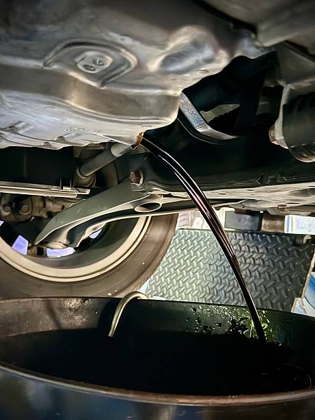 istock Draining engine oil during car maintenance service 2218185409