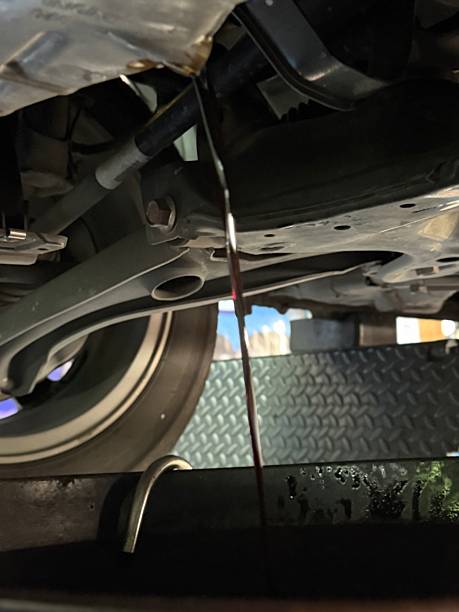 istock Draining engine oil during car maintenance service 2218185419