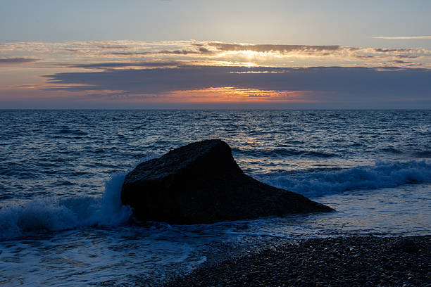 istock A large rock sits on the beach, with the ocean in the background 2218185842