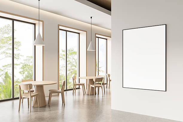 istock Modern cafe interior with blank framed poster mockup on white wall near large windows and wooden furniture under pendant lights. 3D Rendering. 3D Rendering 2218186647