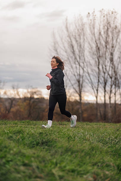 istock Woman running in a meadow on a cloudy day 2218186744