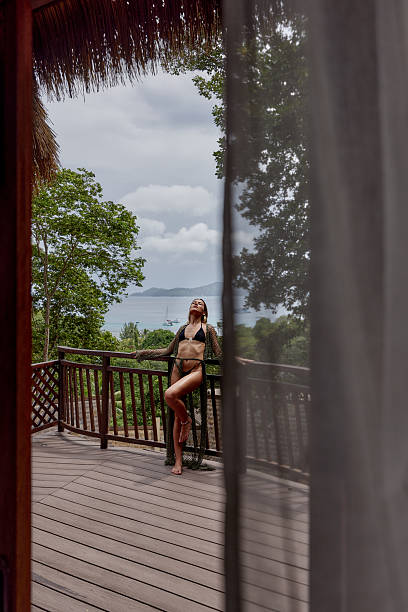 istock Young sensual woman with closed eyes on a terrace. 2218186838