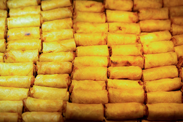 Fresh and healthy vietnamese spring rolls with soy sauce dipping, served on long white plate, on isolated white background