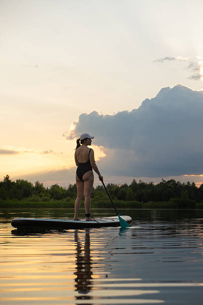 istock Paddleboarding at Sunset on a Tranquil Lake 2218192273