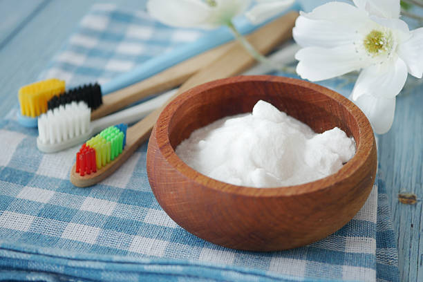 istock Tooth care essentials with baking soda and colorful toothbrushes 2218195695