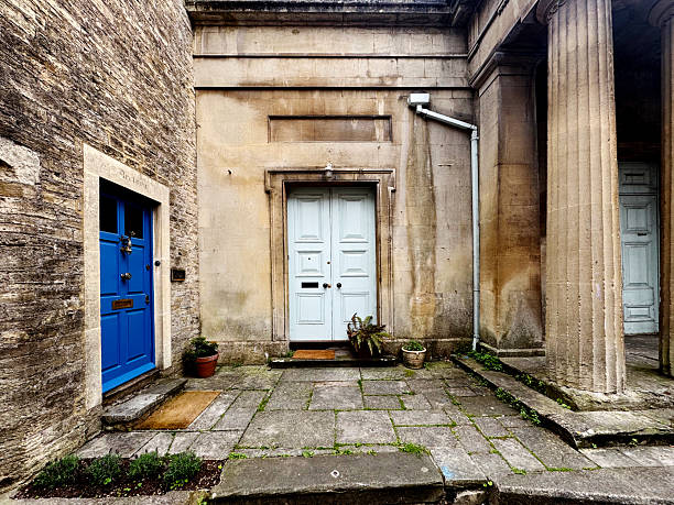 Exterior, flag stones and front doors of Georgian style apartments in a residential district of Frome in Somerset