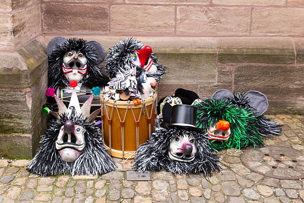 Breznik, Bulgaria - January 20, 2024: Unidentified people with traditional Kukeri costume are seen at the Festival of the Masquerade Games Surova in Breznik, Bulgaria.