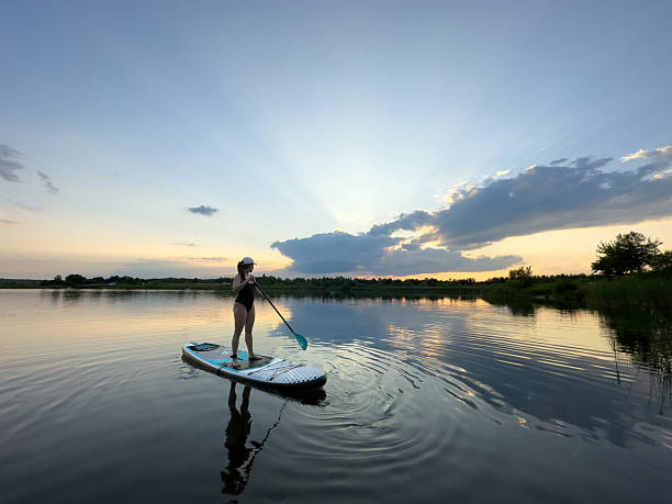 istock Paddleboarding at Sunset on a Tranquil Lake 2218197714