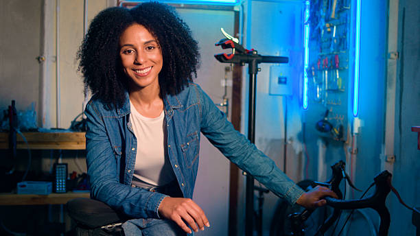 istock Confident Woman Smiling in a Workshop with Blue Neon Lighting 2218198864