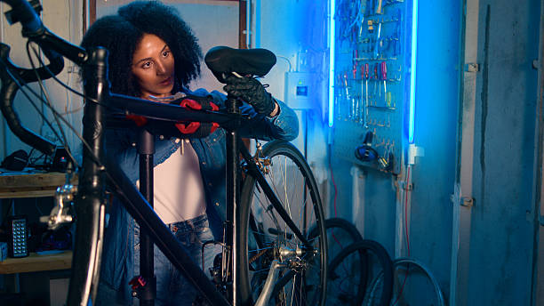 istock Mechanic Working on Bicycle in Workshop with Tools and Neon Lights 2218198871