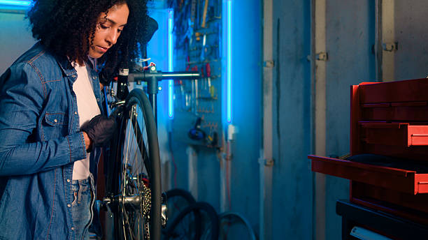 istock Mechanical Repairs on a Bicycle in a Well-Lit Workshop Setting with Neon Lights 2218198874