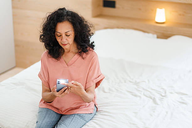 istock Hispanic Woman Using Phone to Measure Heart Rate 2218200104
