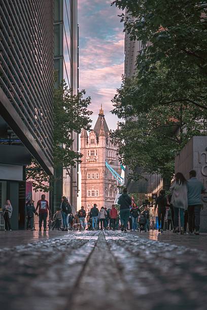 London, United Kingdom – June 02, 2022: Crowds walking along the London Riverside near Tower Bridge on a sunny day.