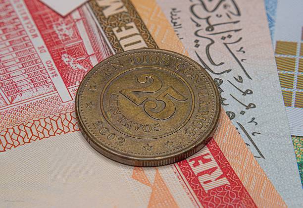 istock 25 centavos coin on international banknotes 2218202827