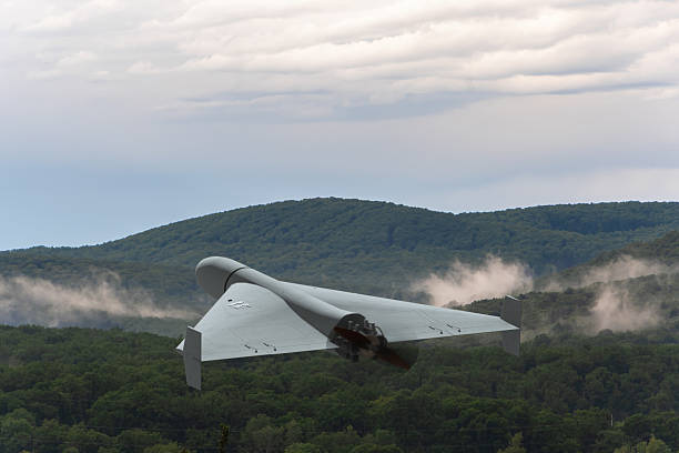 istock A military drone flies over the green hills. 2218205608