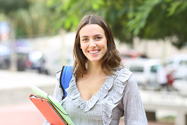istock Student posing smiling looking at camera in the street 2218205809