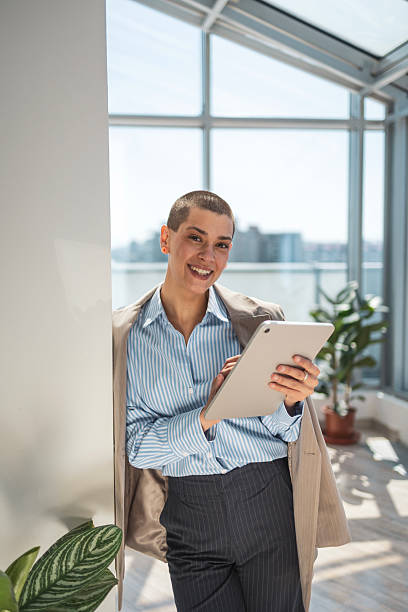 istock Professional individual using tablet in sunny modern office with green plants 2218206834