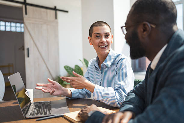 istock Diverse professionals engaged in a discussion in a sunny modern office space 2218206856
