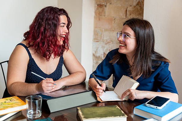 istock Writers smiling and sharing ideas during book club meeting 2218207191