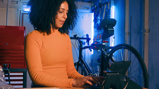 istock Young Woman Using a Digital Tablet in a Bicycle Repair Workshop 2218207492