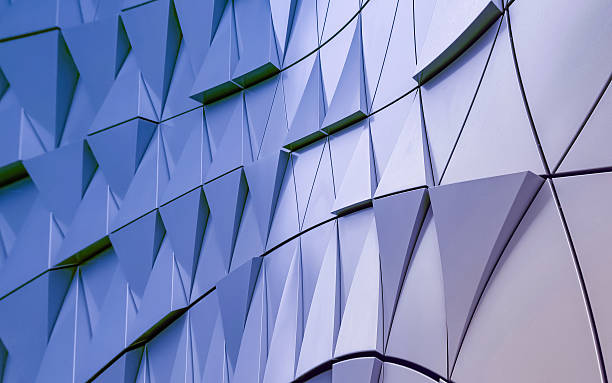 istock Modern architectural detail featuring a textured facade with repeating blue and white triangular panels creating a dynamic and geometric surface 2218207617