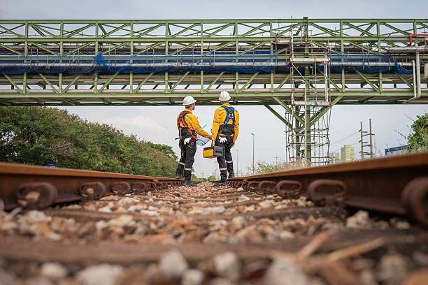 istock Surveyor engineers team wearing safety uniform checking inspection by  inspection and checking construction process railway switch and checking work on railroad site is industry transportation concept. 2218208602